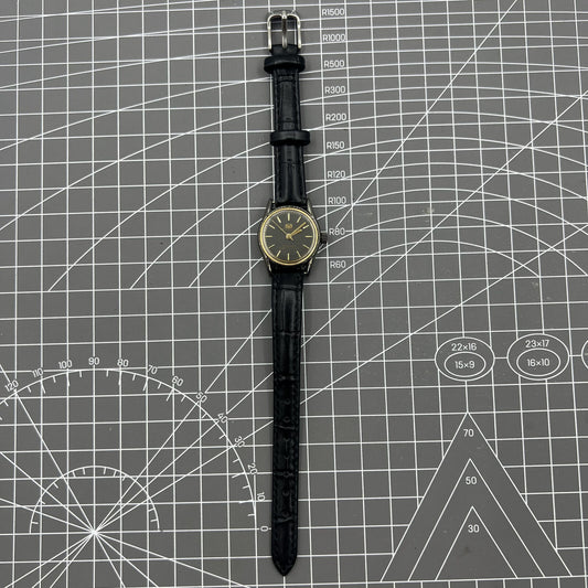 Black case Seagull ladies watch with golden nail markers, manual mechanical movement, and shock-resistant design.