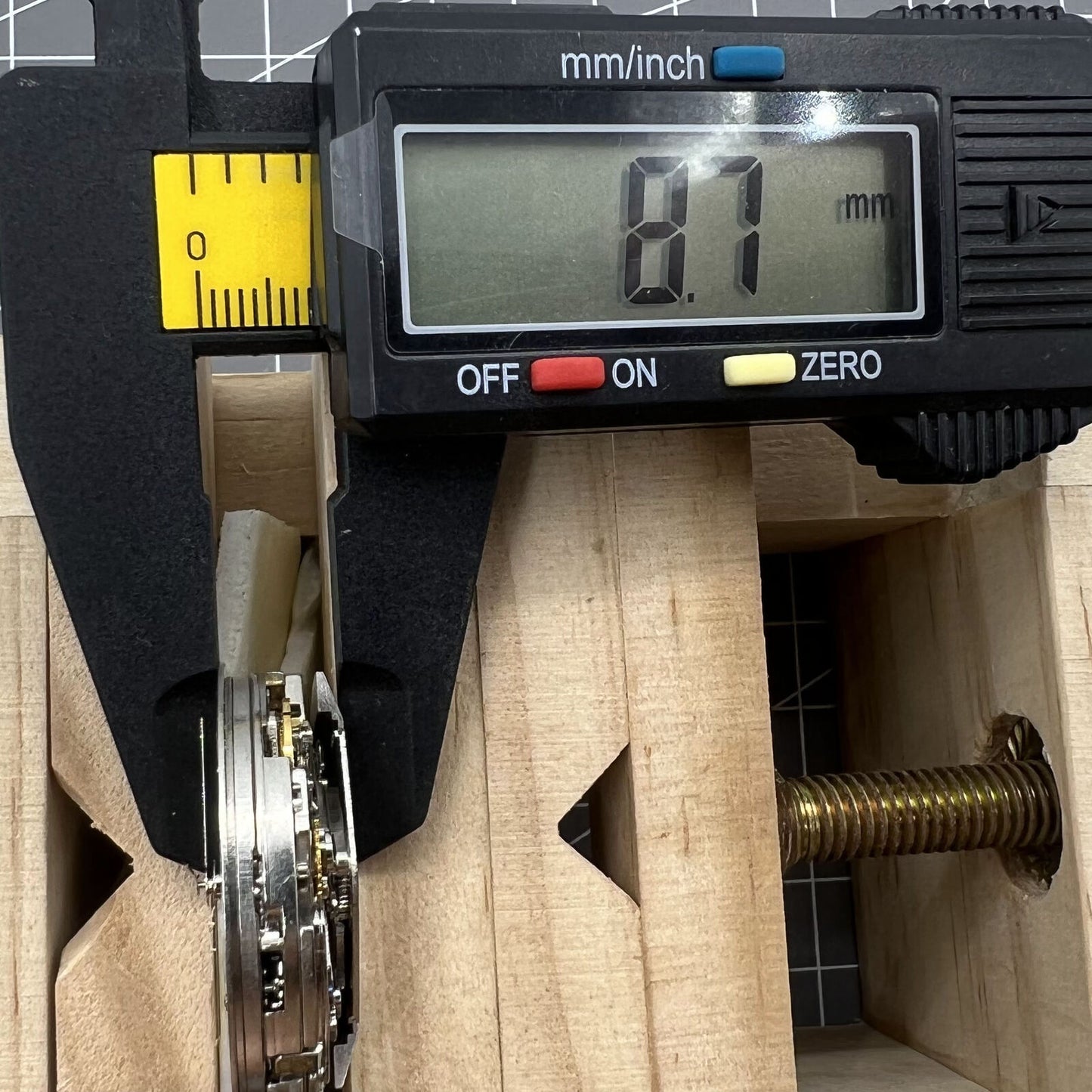 Asia Made 7750 black mechanical watch movement showing single calendar and small seconds at 3, 6, 9 o'clock positions.