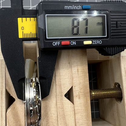 Asia Made 7750 black mechanical watch movement showing single calendar and small seconds at 3, 6, 9 o'clock positions.