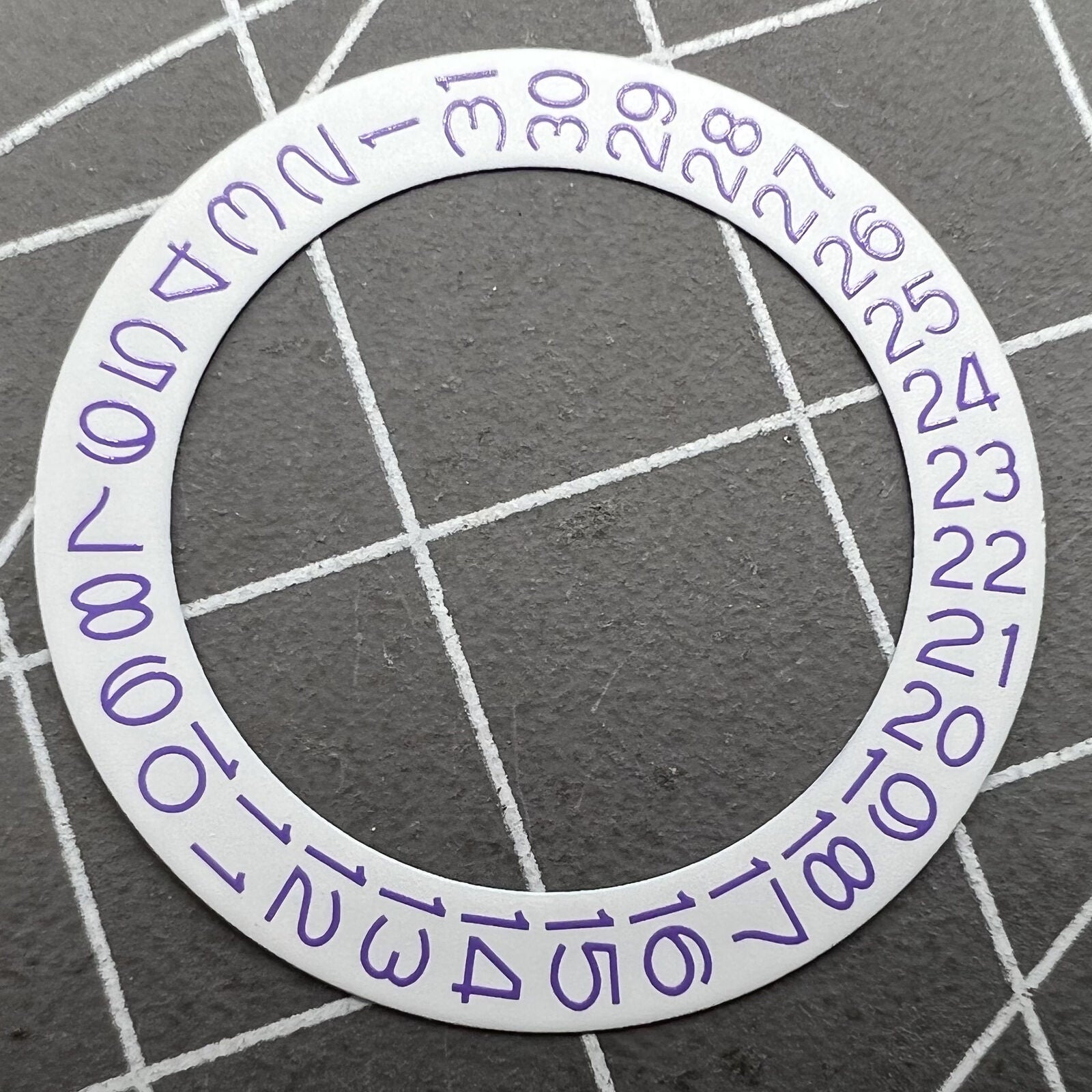 Light purple character disk date wheel for Miyota NH35 NH36 watches with white background.