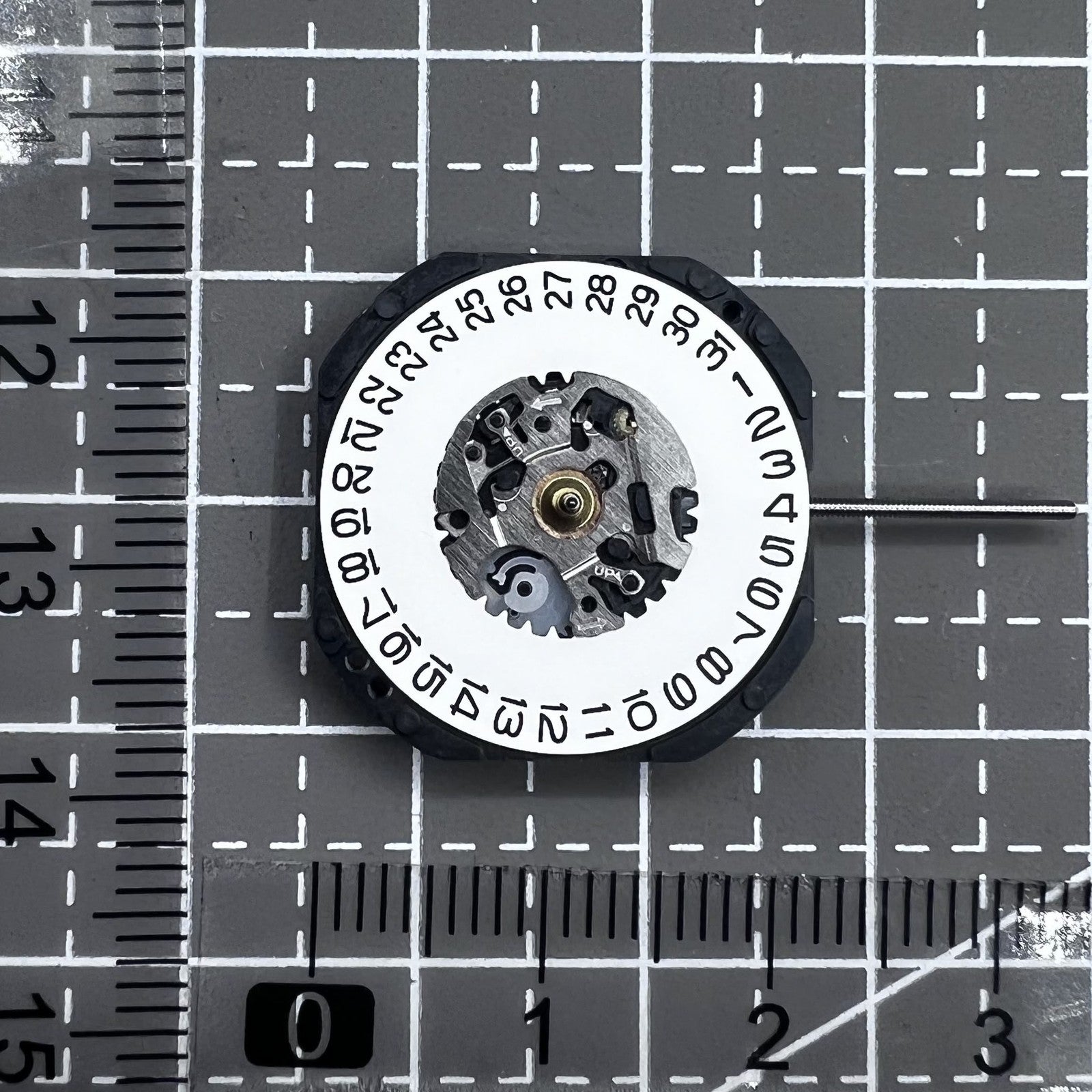 Seiko 7N32C Quartz watch movement showing three hands and single date at 3 o'clock for watch accessories.
