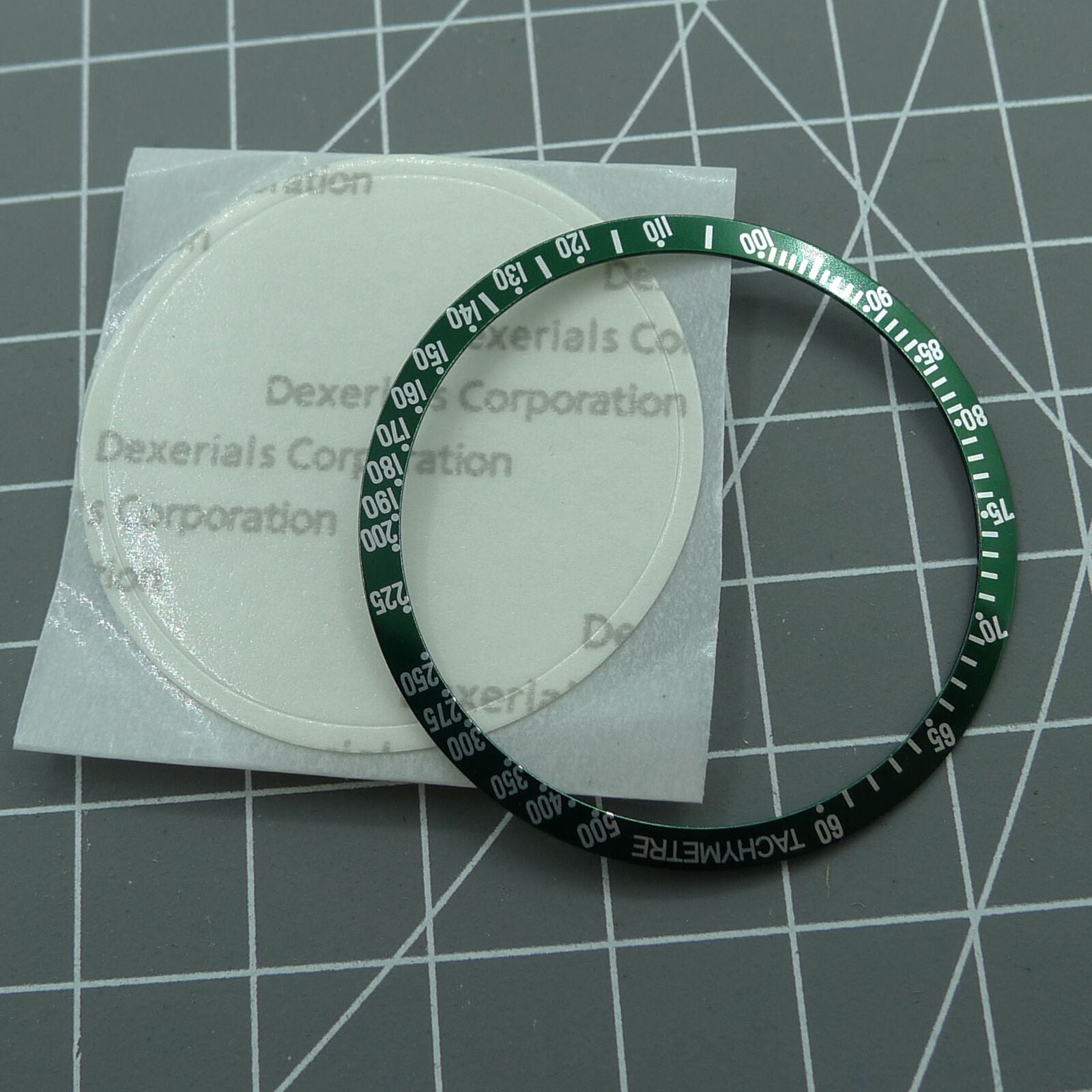 Omega Speedmaster 38.5mm green aluminum alloy bezel with white font, durable watch accessory.