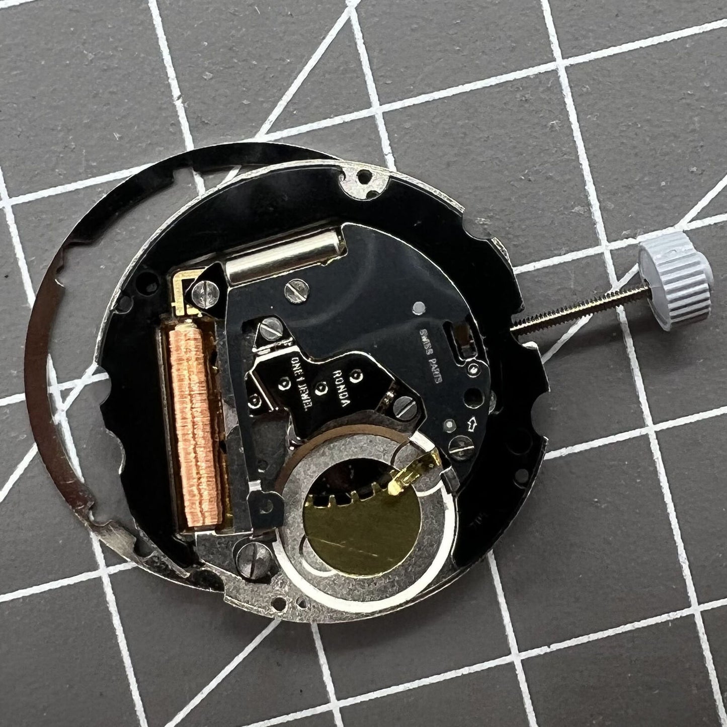 Swiss Made Ronda 705 quartz watch movement with date display at 3 o'clock for precision timing.