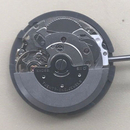 Epson NH06A watch movement showcasing double calendar and date at 3 o'clock position, Japan made.