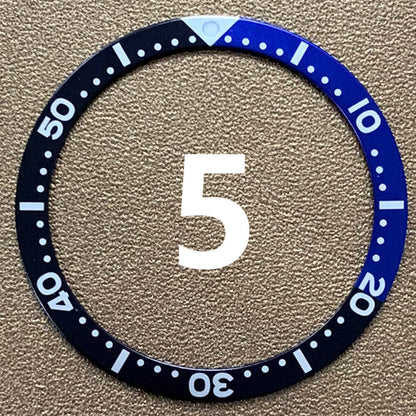 Red, blue, and black aluminum bezel insert for 39mm/32mm watch, enhancing style and durability.