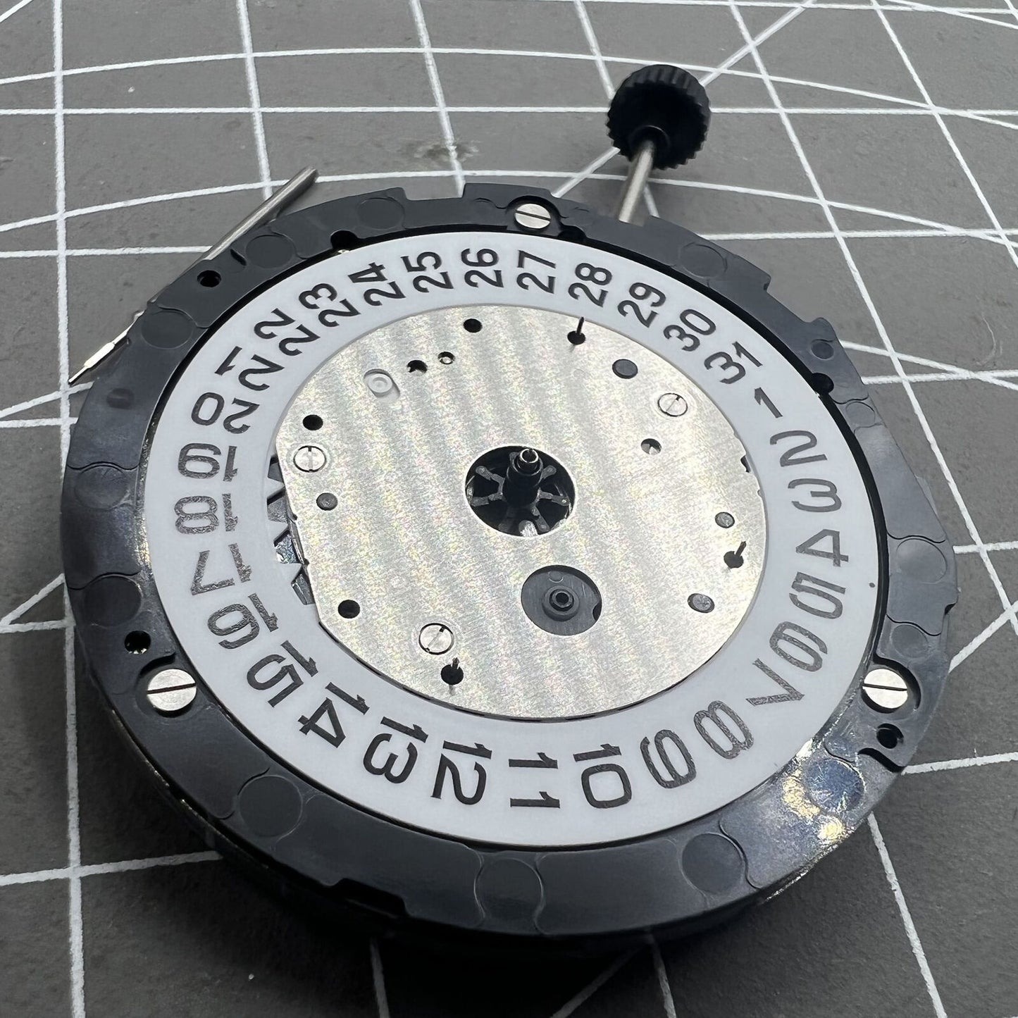 Miyota 6S20 quartz watch movement with date at 3, three hands, small seconds at 6 and 9, precision timekeeping.