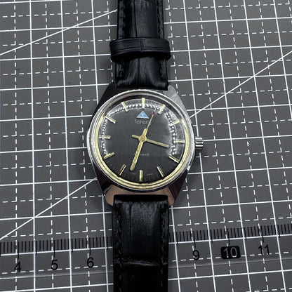 Taihang 32mm manual mechanical watch with black strap, gold markers, and black dial for classic elegance.