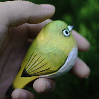Handmade white-eye bird wooden figurine, charming decorative artwork for home or office.