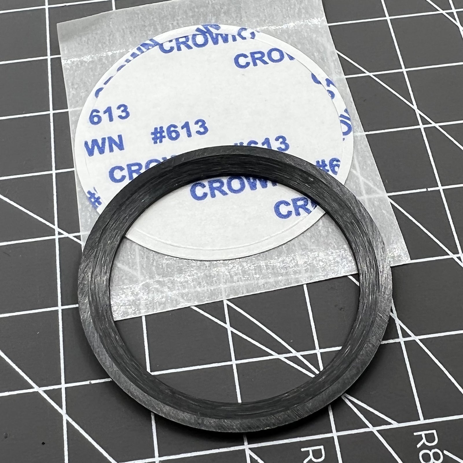 38mm black ceramic bezel insert with orange markers, durable and precise for watch time tracking.