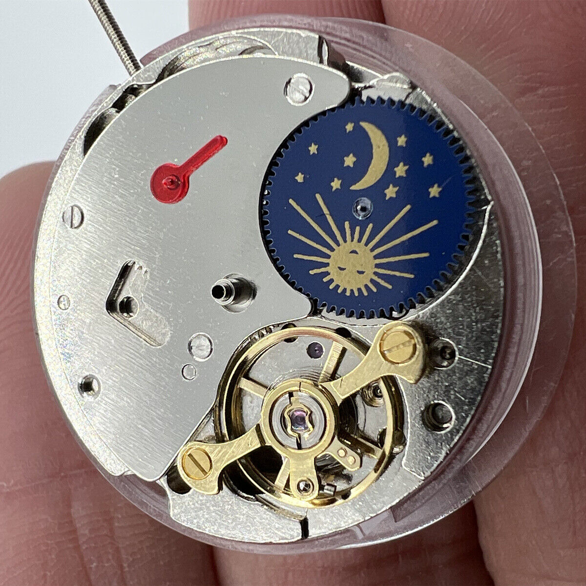 China Made 7120 automatic watch with mechanical movement, balance wheel at 9 o'clock, and moon phase at 6 o'clock.