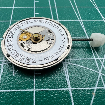 Wholesale Swiss ETA 955.414 quartz watch movement with silver finish and date display at 3 o'clock.