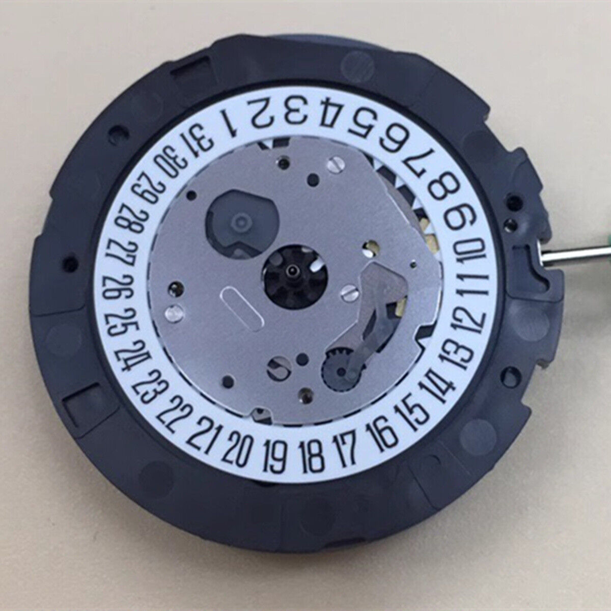 Miyota OS21 quartz watch movement with small seconds at 3 and 9, single calendar at 6, precise timekeeping accessory.