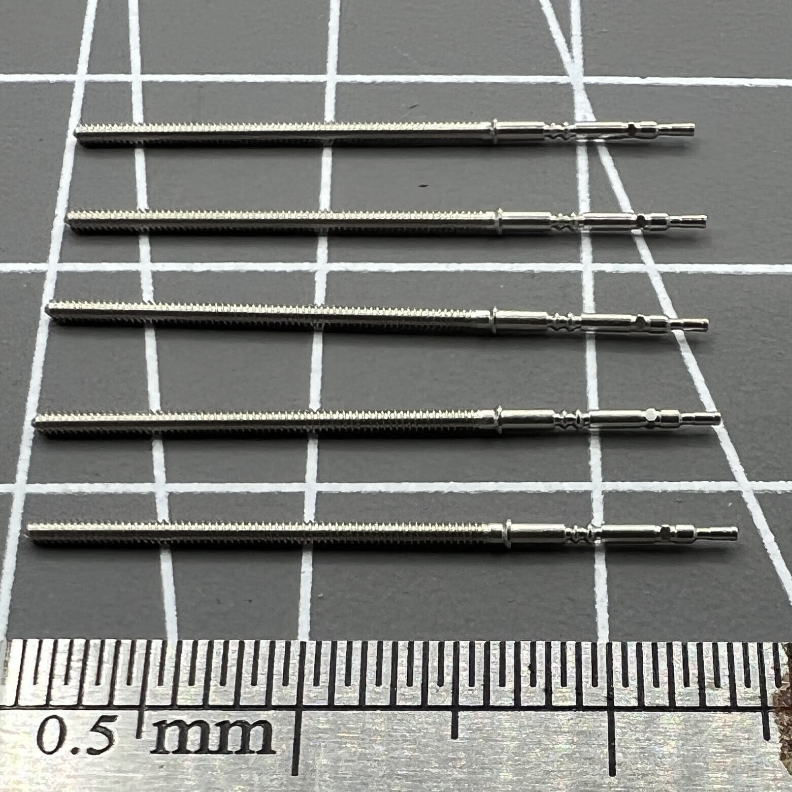 Set of 5 replacement winding stems for PE90 movement watches, durable and precise watch accessory.