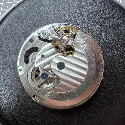 Small silver hollow watch movement with double mainspring and balance wheel at 6 o?clock by Kleines brand.