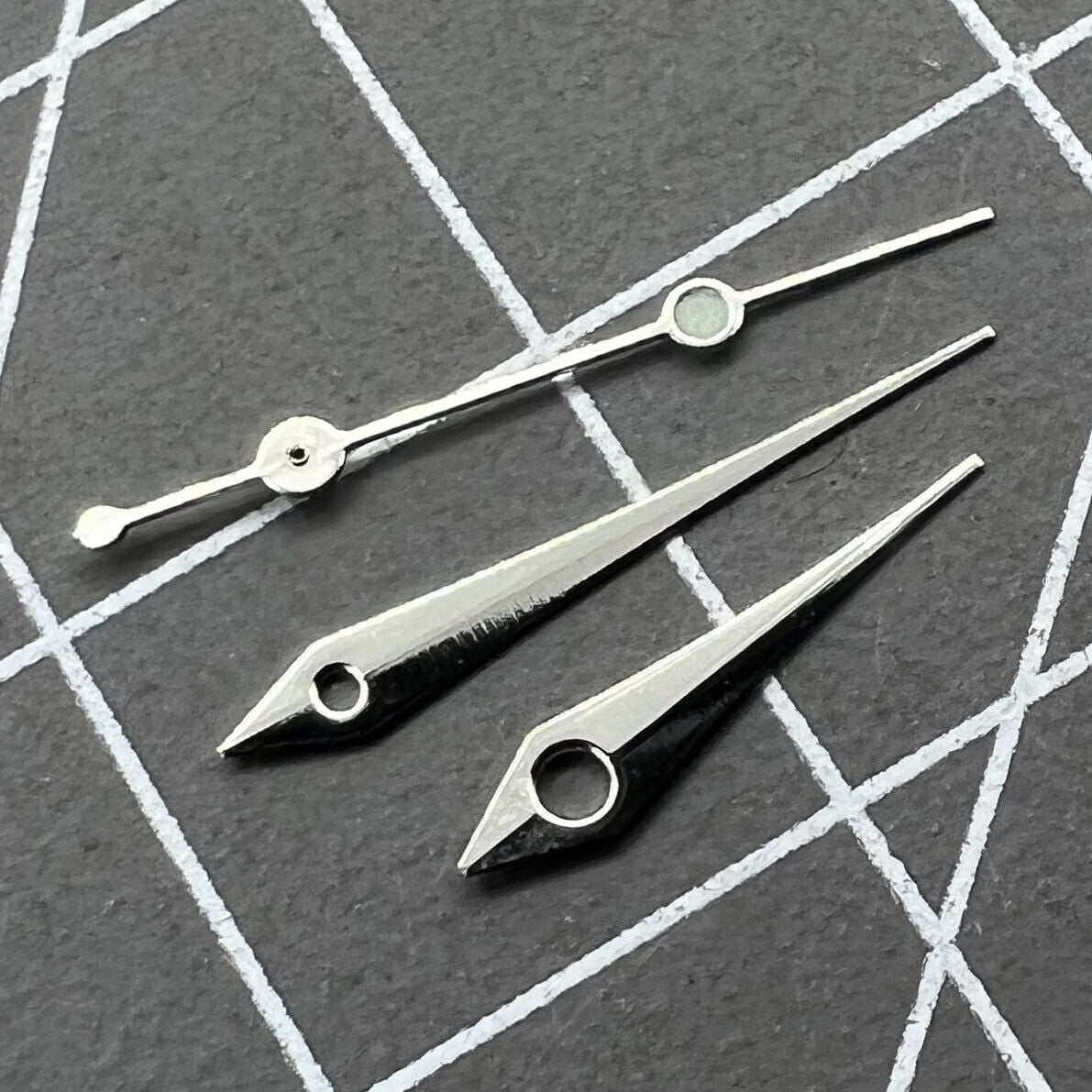 Silver 13mm arrow-shaped watch hands set by Trim for Ronda 515 quartz watches, precise timekeeping parts.