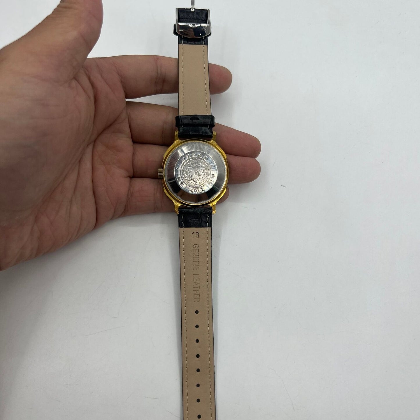 37mm automatic watch with black dial, golden Roman numerals, and 33 jewels.