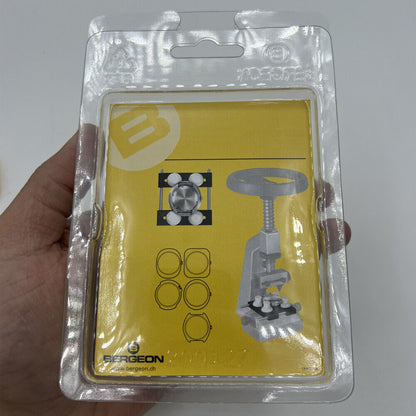 Bergeon 5674 vise jaws securing watch case for precise repair with 5700-Z tool in workshop