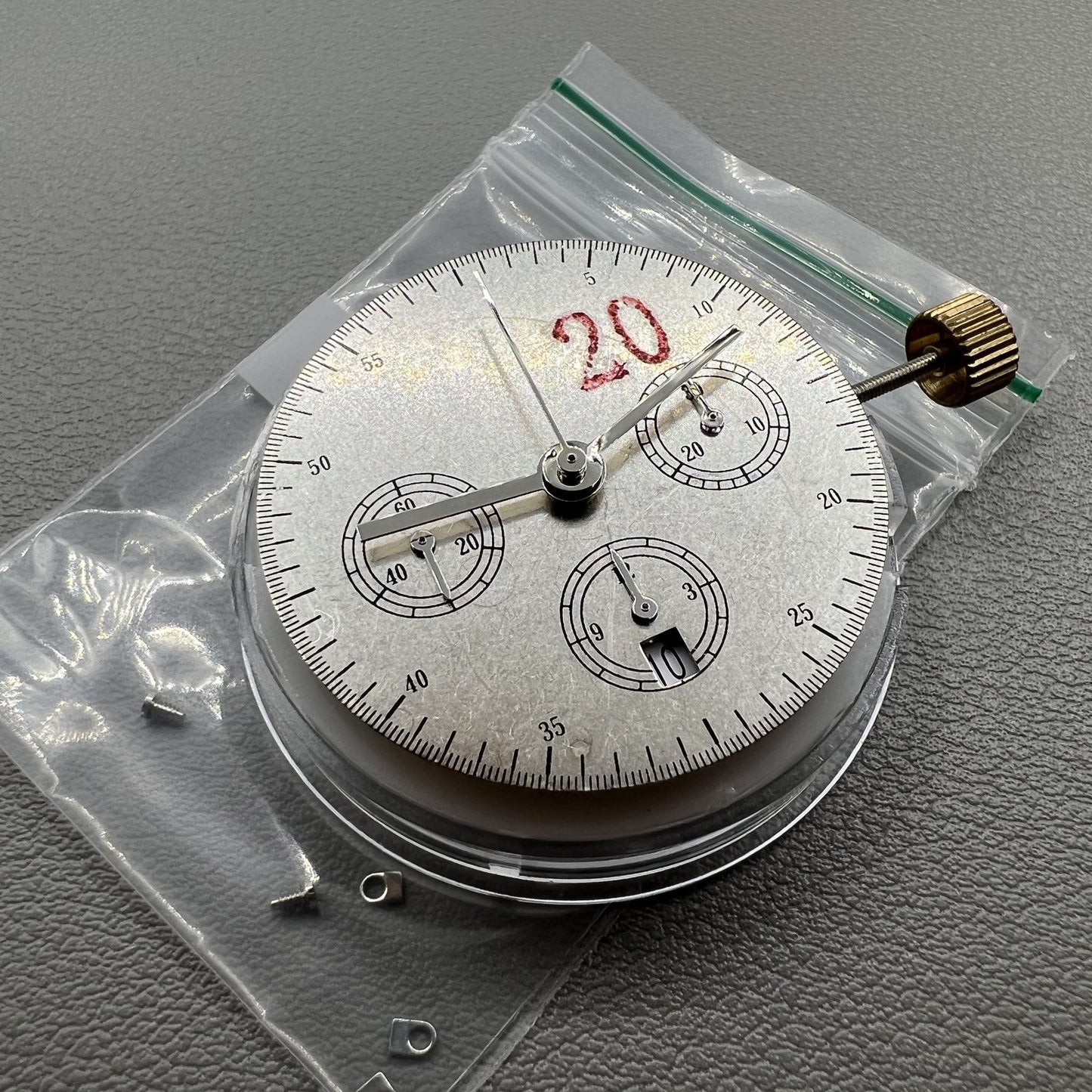 Chronograph watch accessory with ETA 7750 movement, white dial, calendar at 6, second hand at 9.