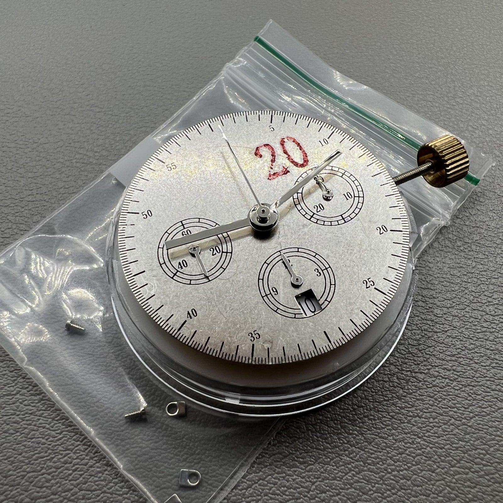 Chronograph watch accessory with ETA 7750 movement, white dial, calendar at 6, second hand at 9.