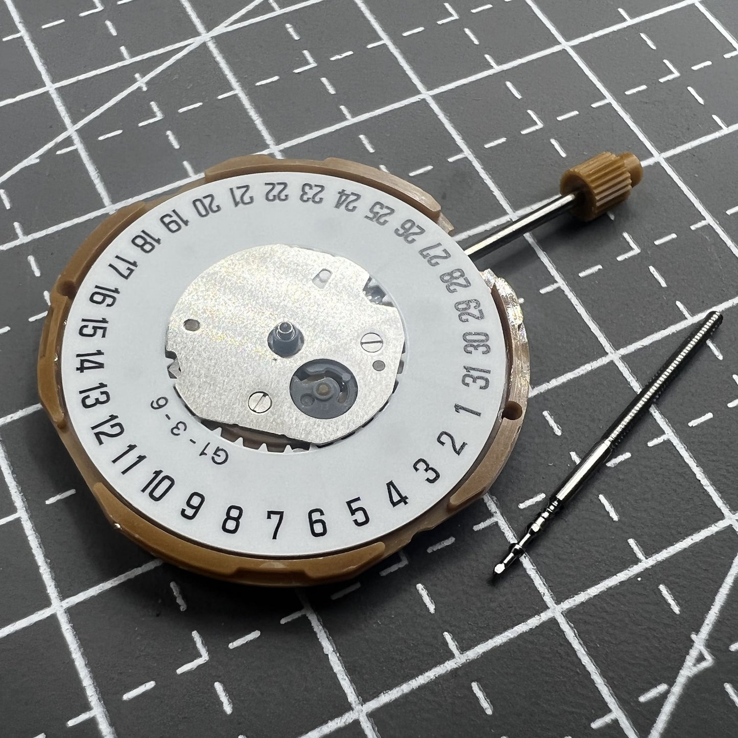 Japan Miyota GM10 watch movement with date display at 6 o'clock, precise quartz mechanism.