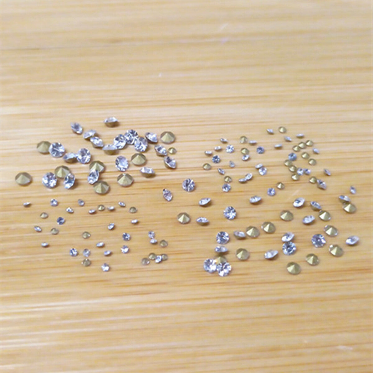 Box of 18 pointed bottom imitation diamonds for watch accessory DIY decoration, enhancing sparkle and style.