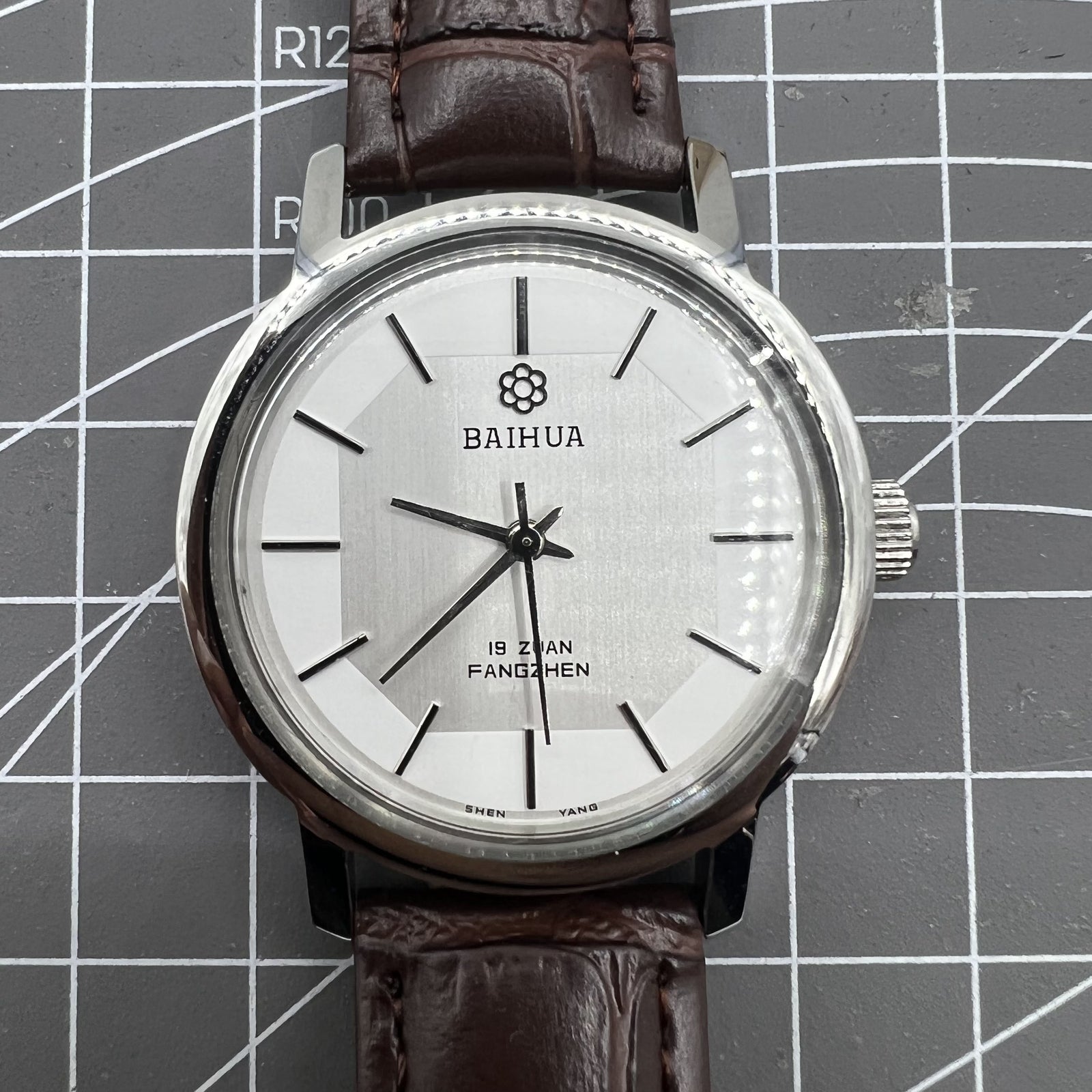 China Baihua 37mm manual mechanical watch with silver dial, 19 jewels, and shock-resistant design for durable precision.