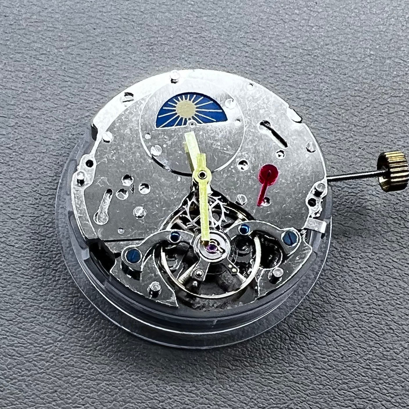 Silver Asian Dandong automatic watch with mechanical movement, date and week indicators, moon phase display.