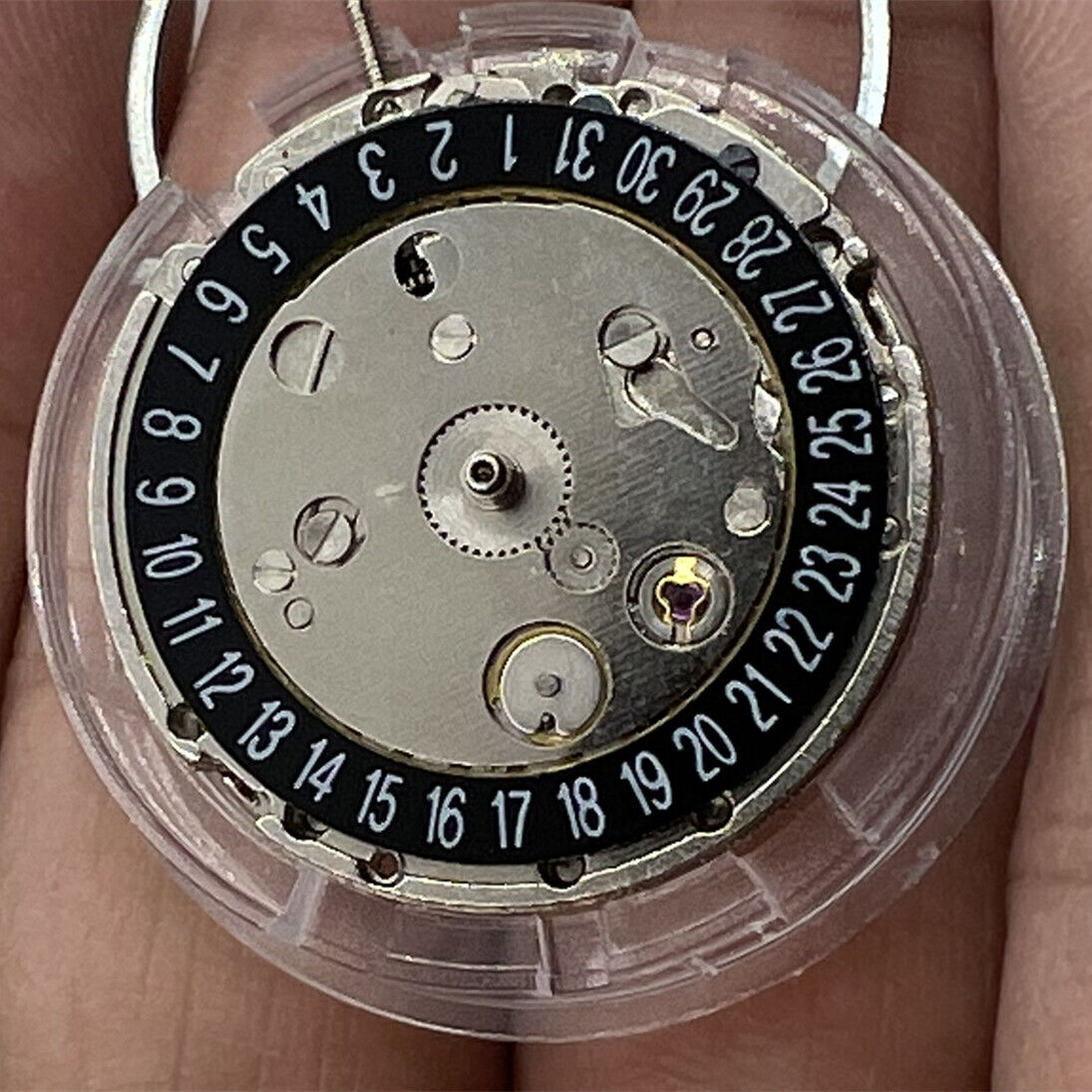 Mechanical watch movement with black dial, day-date calendar at 6, precise 2813 caliber.