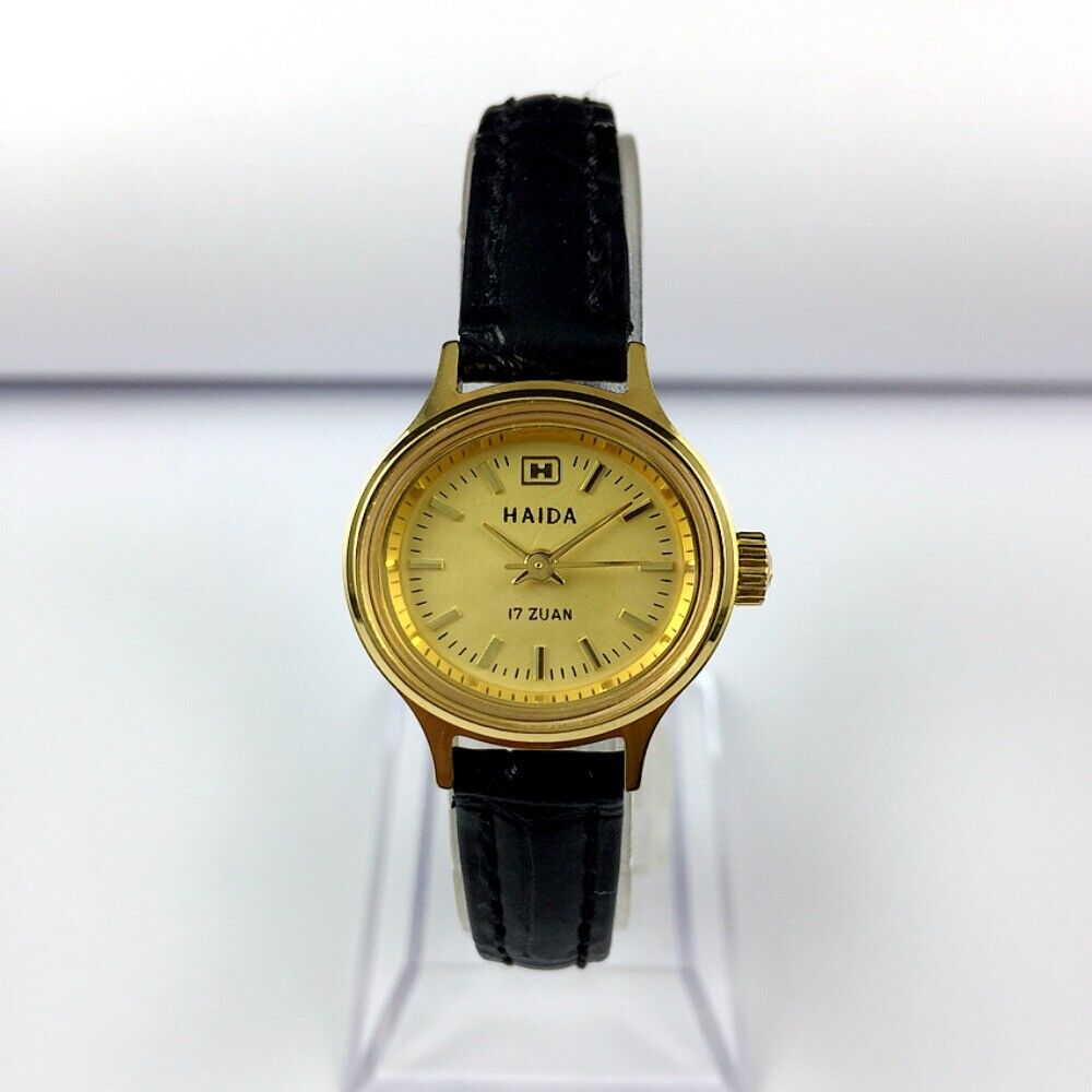 HAIDA 24mm golden lady watch with 17 jewels, mechanical movement, and oval nail-style case design.