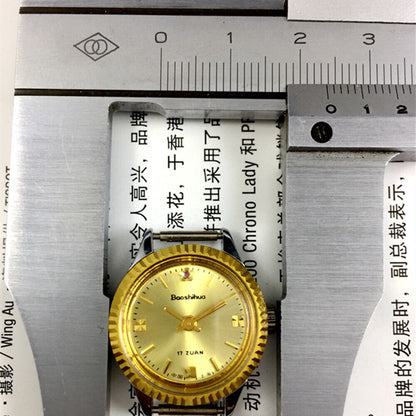 Shanghai 24mm lady watch by Shanghai with golden nail markers, round gold case, and manual mechanical movement.