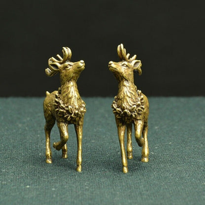 Hand-carved copper Sika Deer figurines, detailed male and female bronze trinkets for watch accessories display.