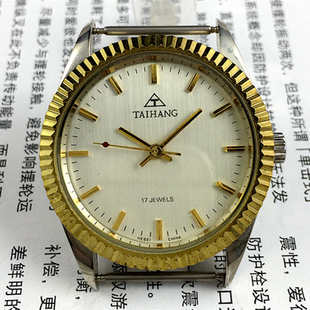 TAIHANG 38mm manual mechanical watch with golden nail markers, silver dial, round case, 17 jewels details.