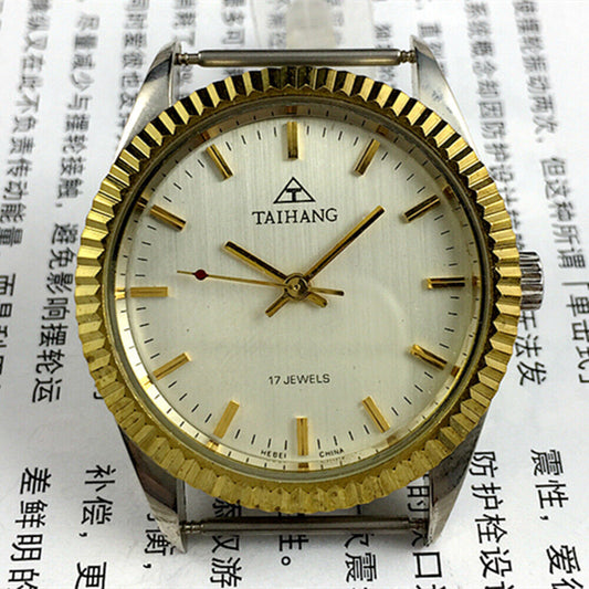 TAIHANG 38mm manual mechanical watch with golden nail markers, silver dial, round case, 17 jewels details.