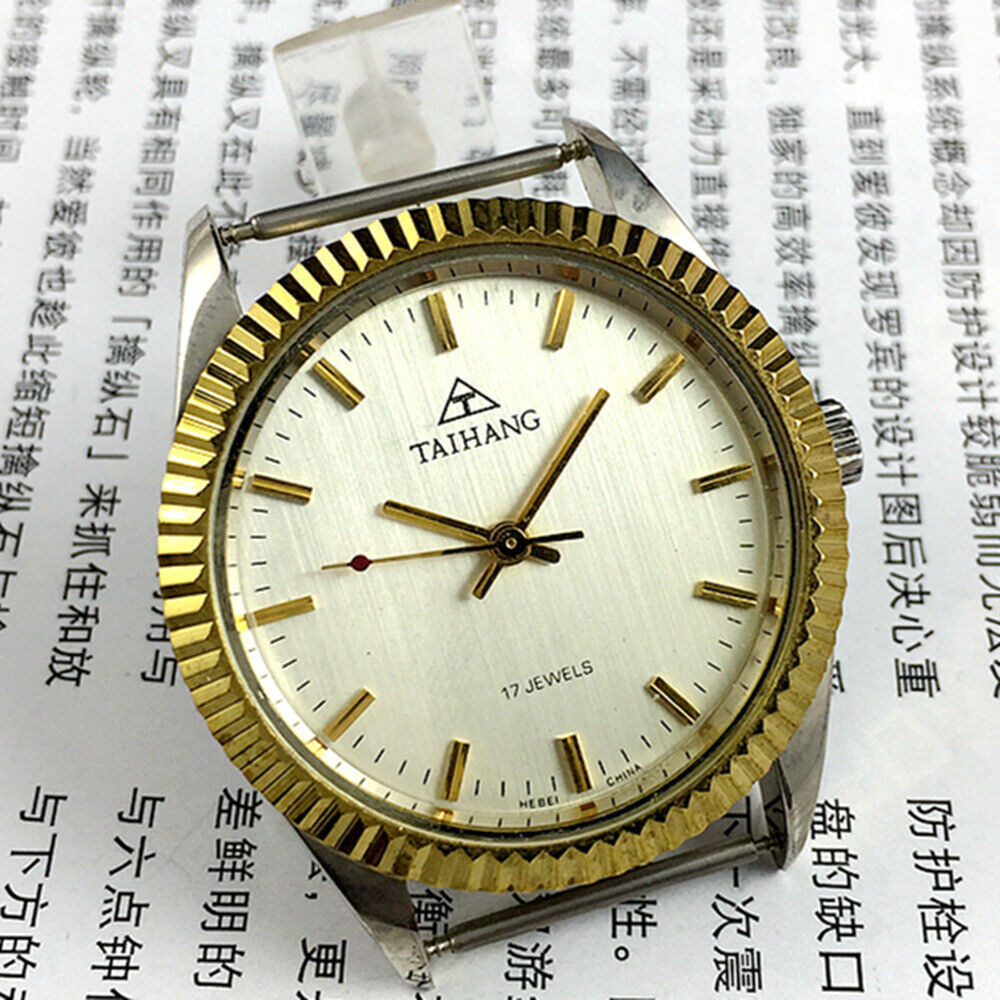 TAIHANG 38mm manual mechanical watch with golden nail markers, silver dial, round case, 17 jewels details.
