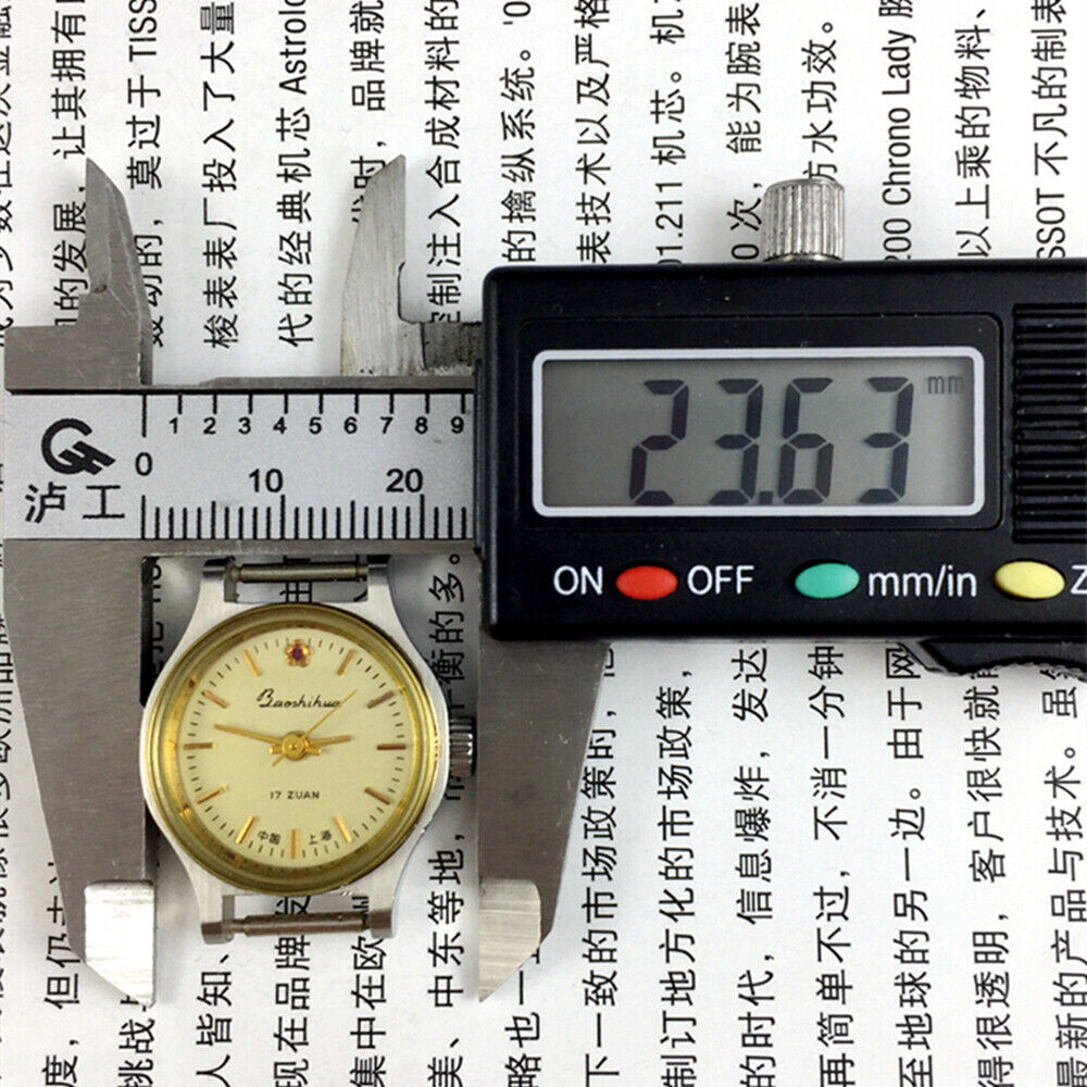 23mm Shanghai Lady Watch with golden nail markers, round case, manual mechanical movement, elegant design.