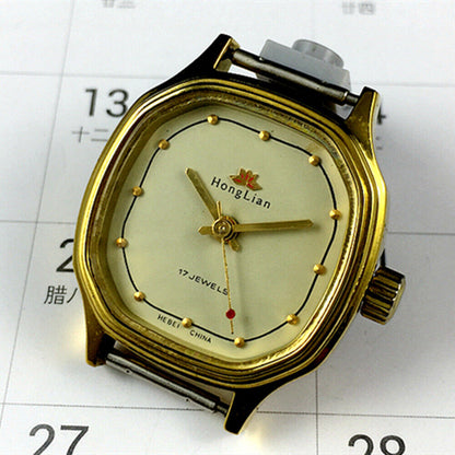 Elegant 27mm HONGLIAN manual mechanical lady watch with golden nail markers and octagonal golden case.