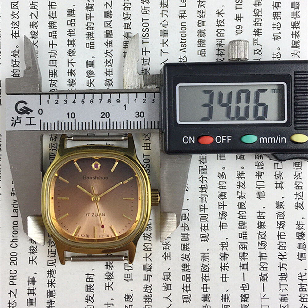 Shanghai 33mm manual mechanical watch with golden indices, 17 jewels, brown dial, and square case by Shanghai brand.