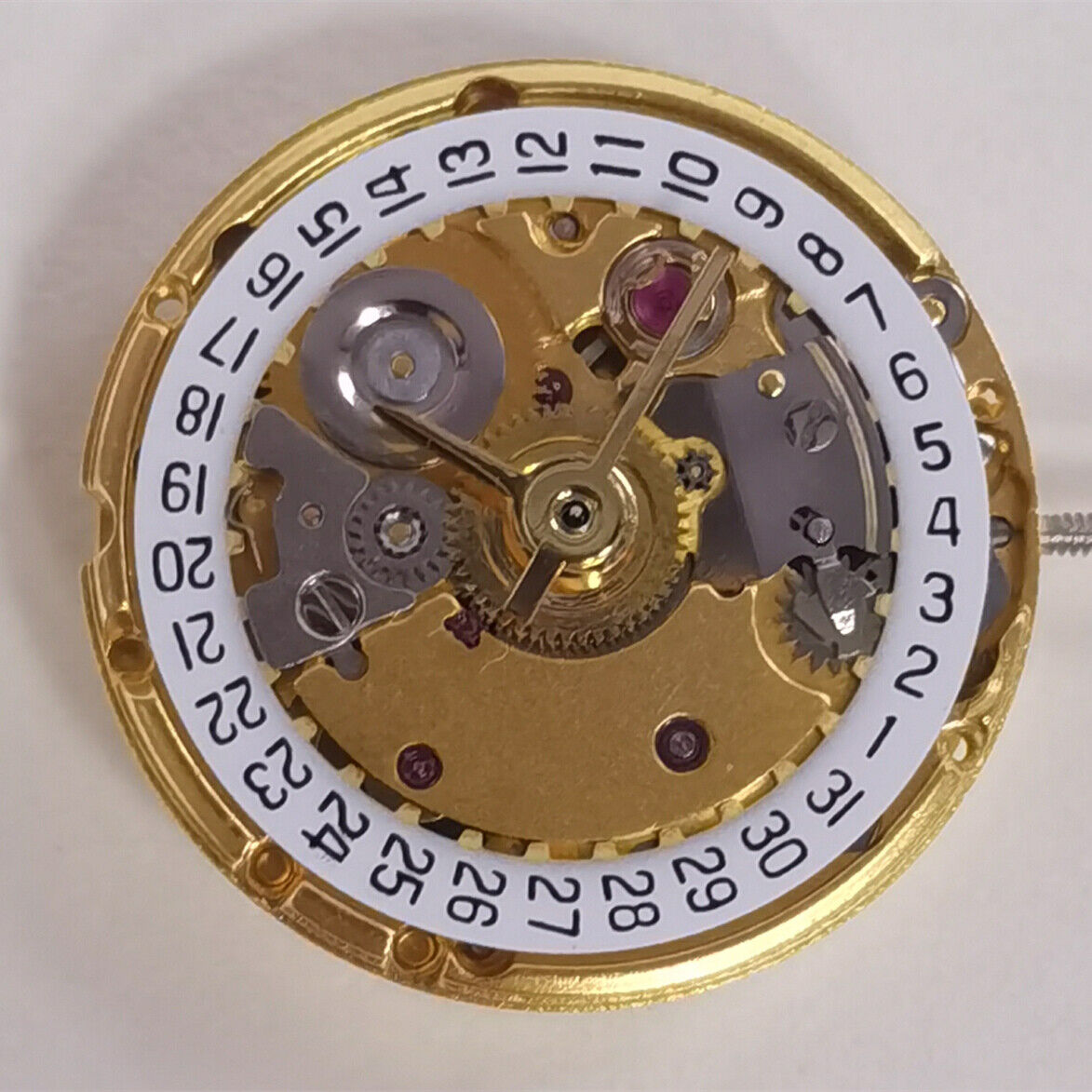 Golden mechanical watch with date display at 3 o'clock, ETA2671 replacement, precision craftsmanship.