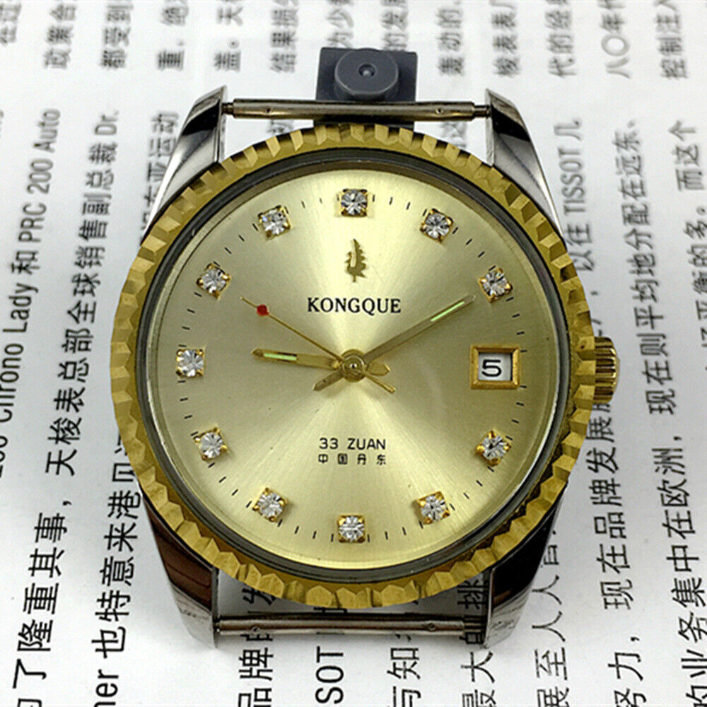 Dandong 37mm Peacock manual watch with golden dial, 33 jewels, and single calendar feature.
