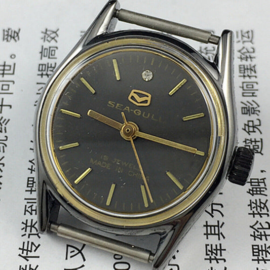 Elegant 26mm Seagull ladies watch with black round case, golden nail markers, and manual mechanical movement.
