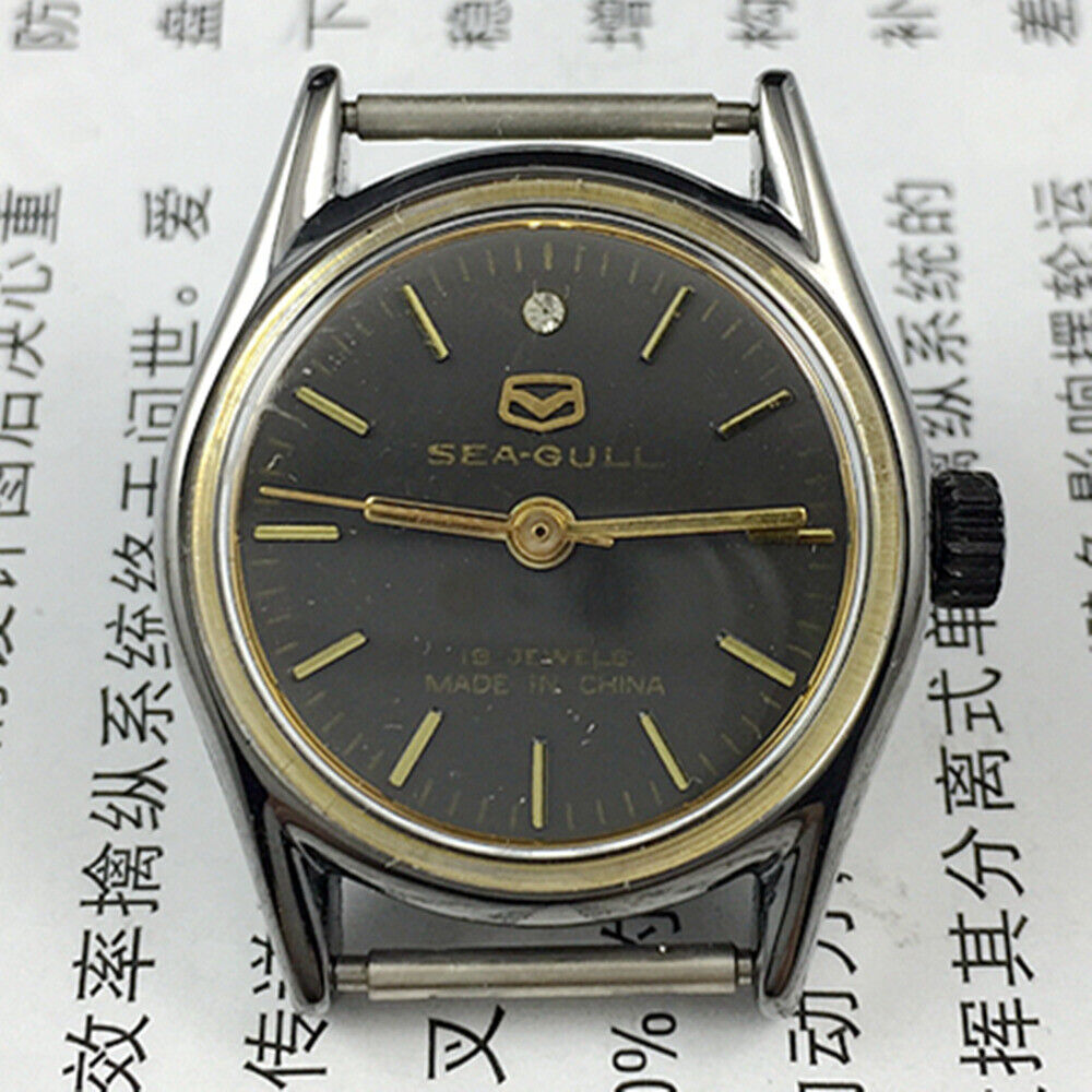 Seagull 26mm ladies watch with black round case, gold nail markers, and manual mechanical movement.