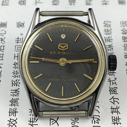 Seagull 26mm ladies watch with black round case, gold nail markers, and manual mechanical movement.