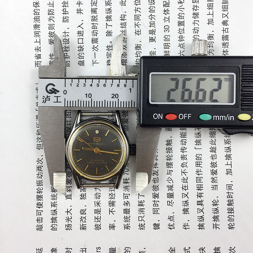 Seagull 26mm ladies watch with black case, gold nail markers, and manual mechanical movement for elegant style.