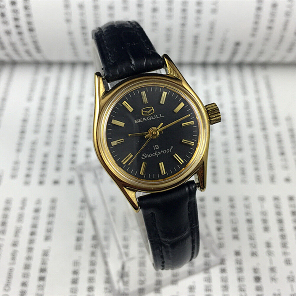 Elegant black round case ladies watch by Tianjin Seagull featuring golden nail markers and manual mechanical movement.