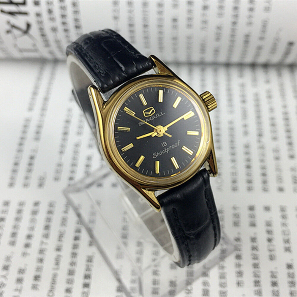 Tianjin Seagull elegant ladies watch with black round case, gold nail markers, manual mechanical movement.