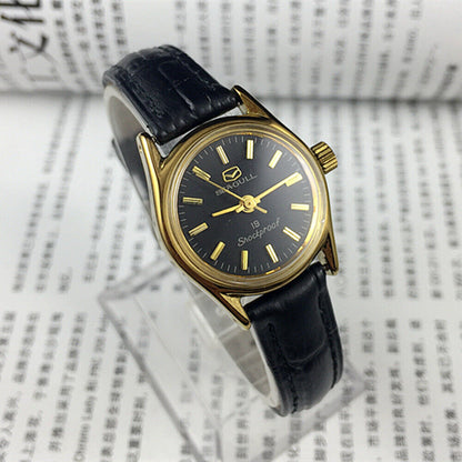 Tianjin Seagull elegant ladies watch with black round case, gold nail markers, manual mechanical movement.