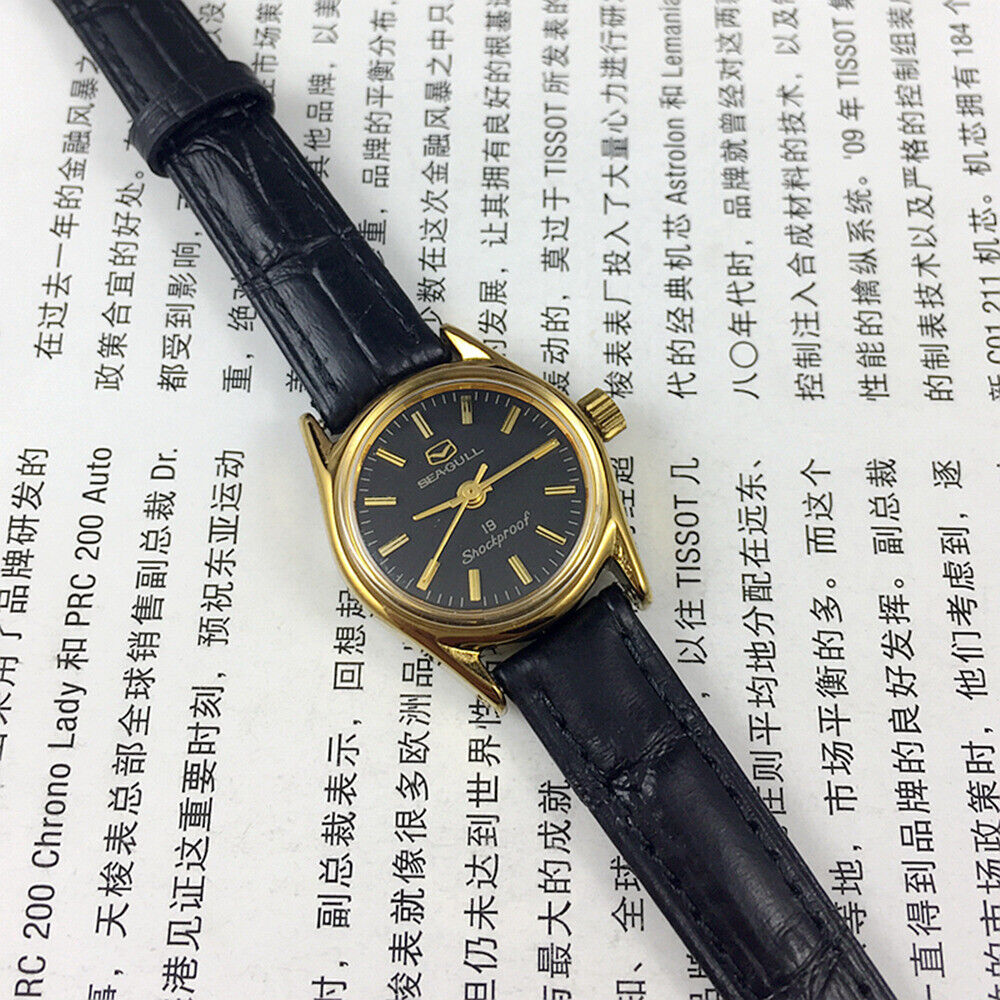 Tianjin Seagull elegant ladies watch featuring black round case, golden nail markers, manual mechanical movement.
