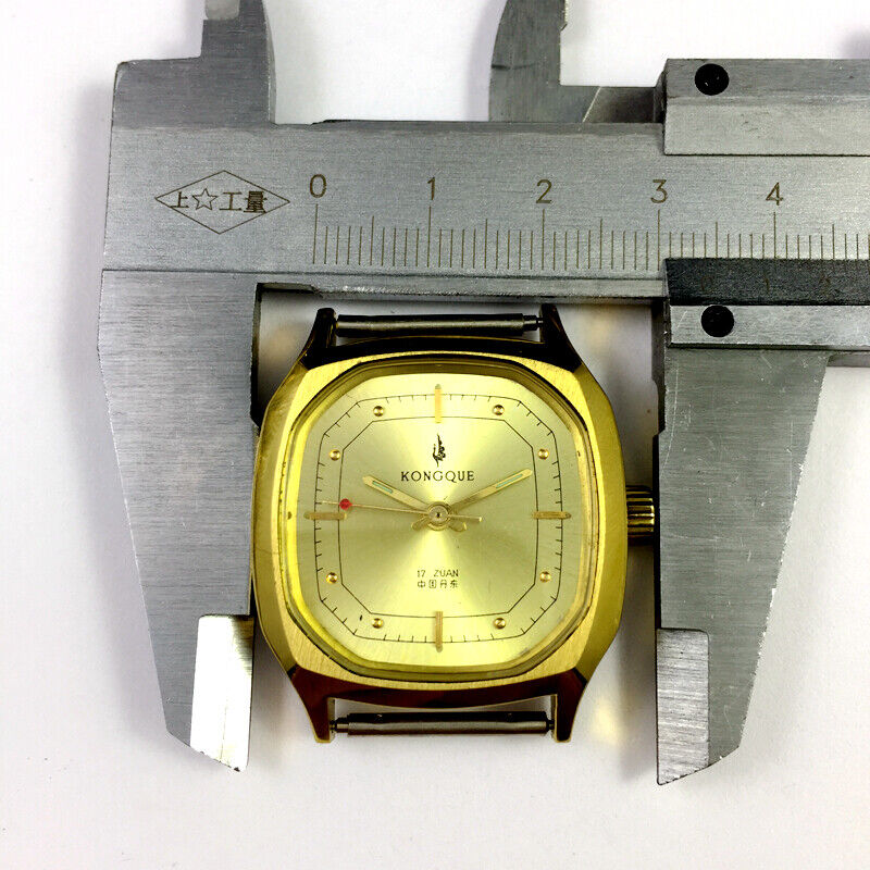 China Kongque 34mm steel manual watch with 17 jewels, golden dial, and nail markers for elegant timekeeping.