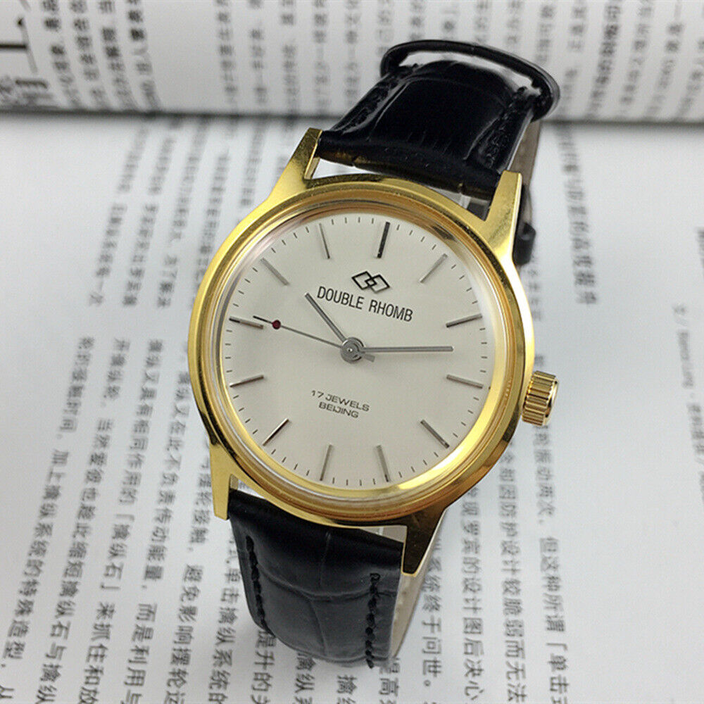 Beijing Double Rhomb manual mechanical watch with golden case and silver nail markers, classic design.