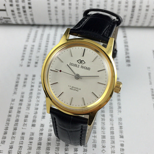 Beijing Double Rhomb manual mechanical watch with golden case and silver nail markers, classic design.